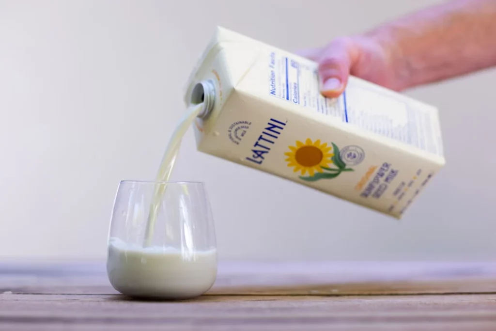 lattini sunflower milk being poured into a glass